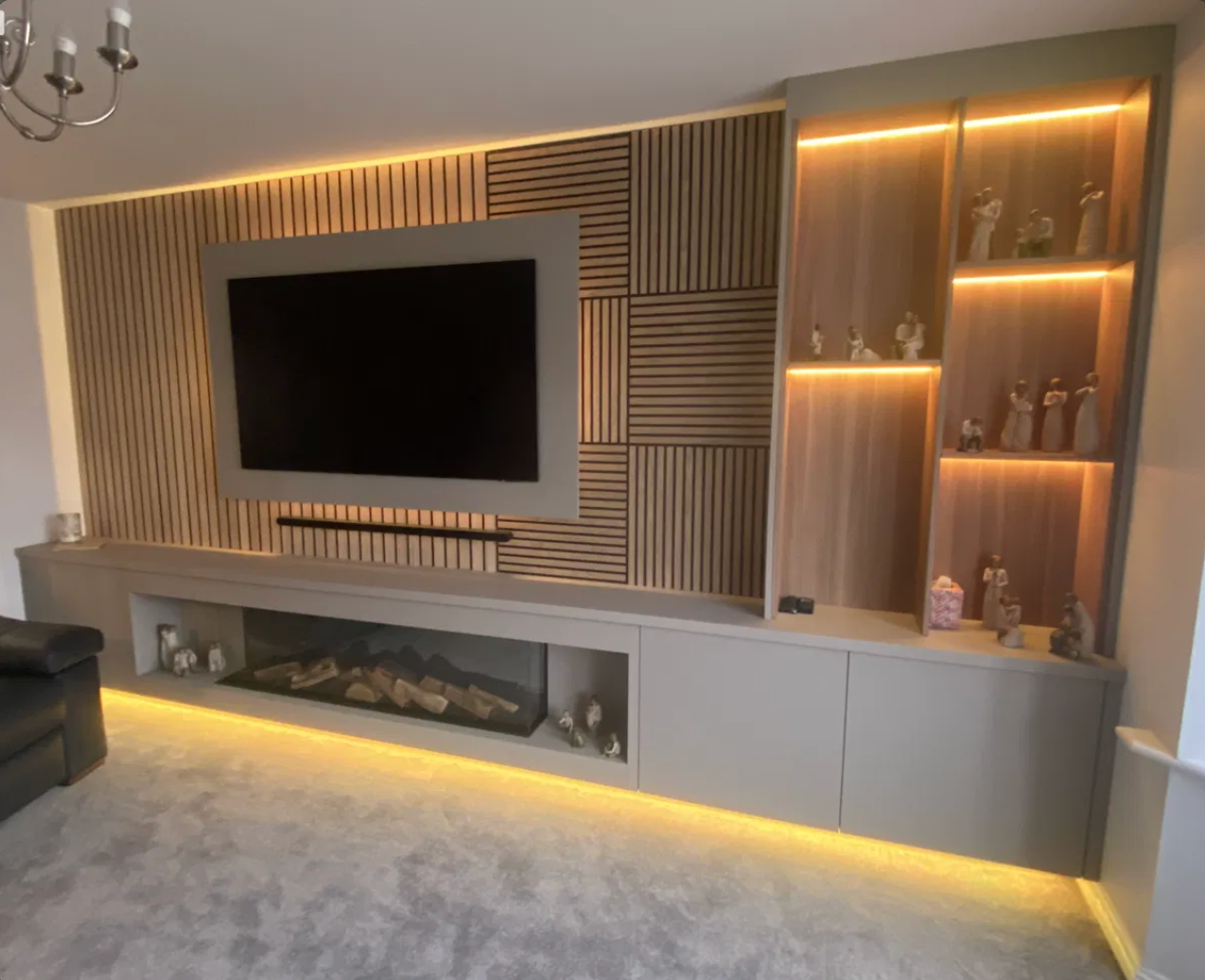 Slatted media wall with backlit display shelving