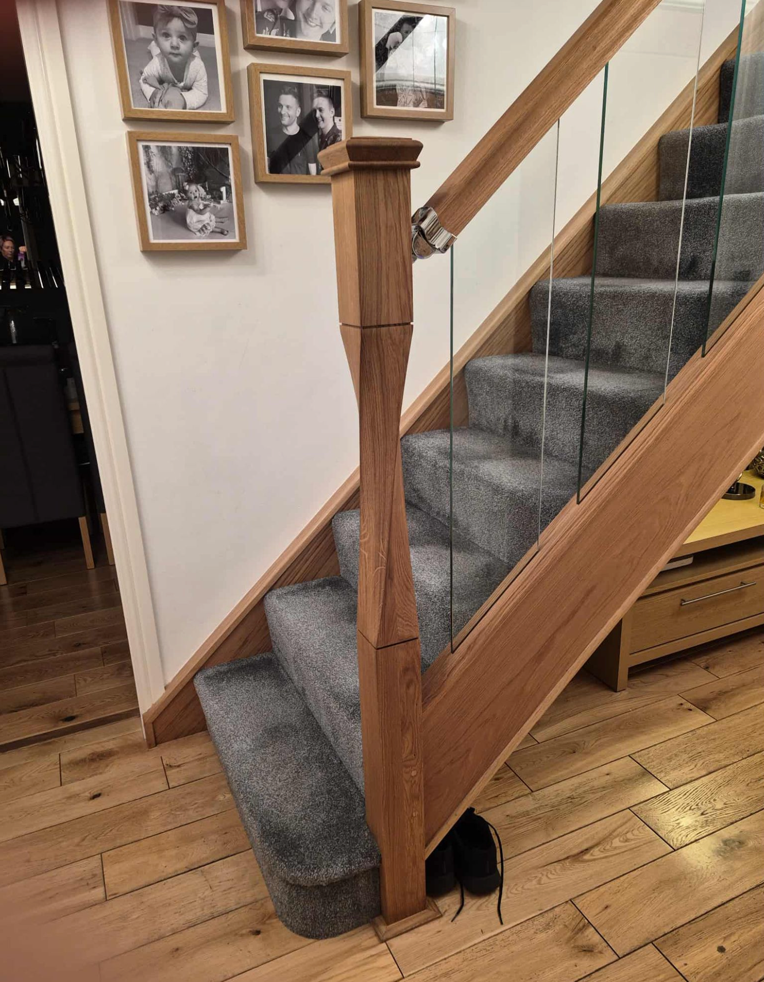 Oak staircase with glass balustrade and turned newel post