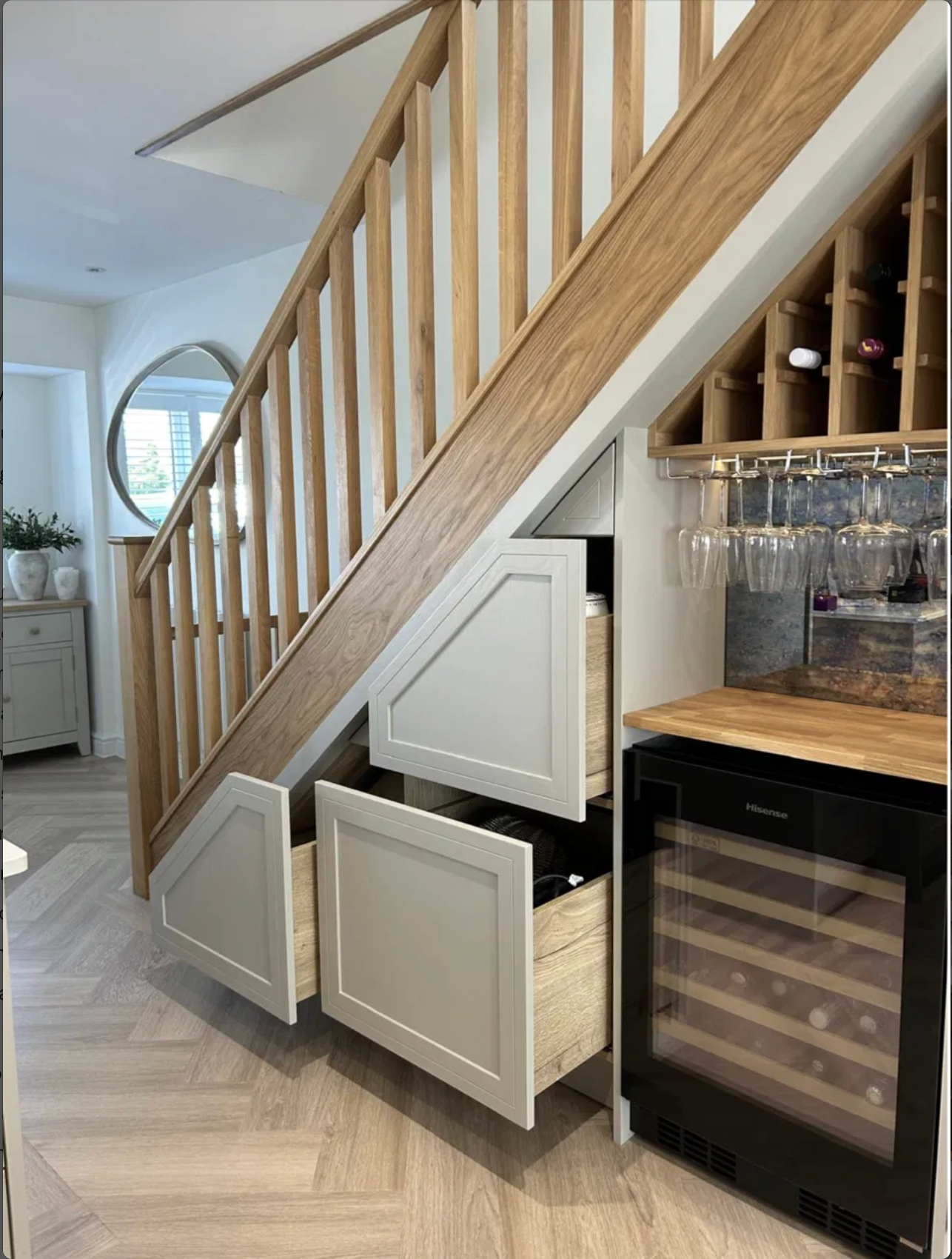 Under-stairs wine storage and glass rack cabinetry